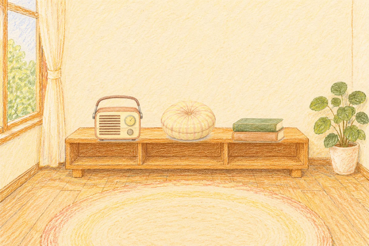 도선동 여성전용 경락 마사지 안내 그림, 낮의 창가 낮은 선반 위에 놓인 작은 라디오, 둥근 쿠션, 책 두 권