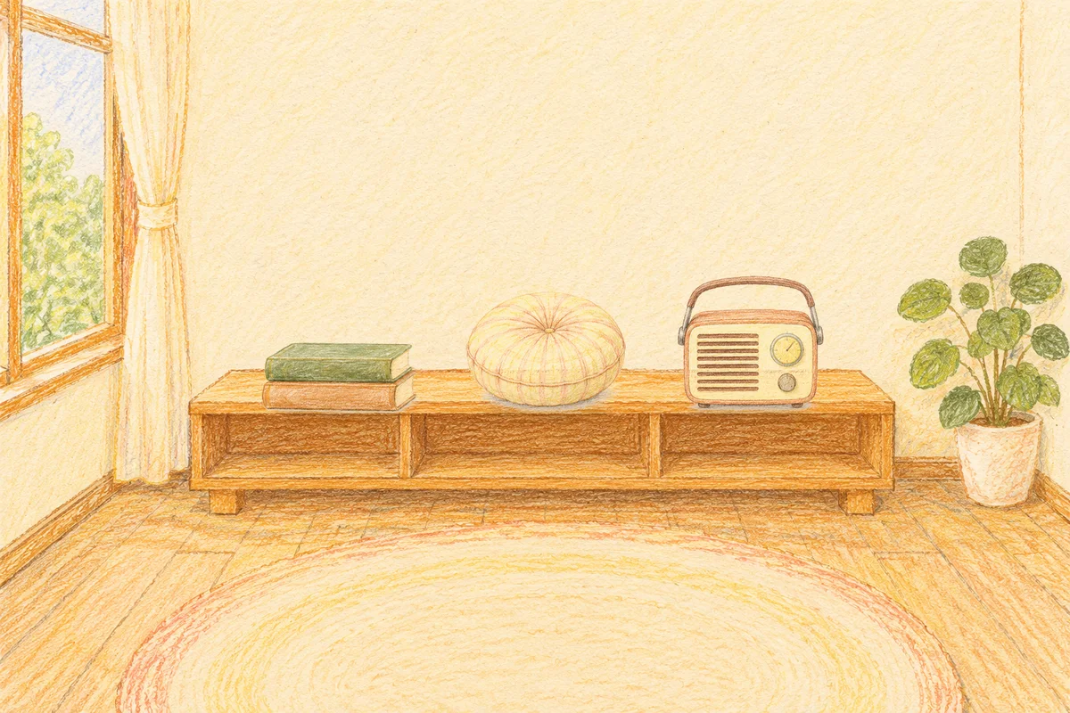 홍익동 여성전용 발마사지 안내 그림, 낮의 창가 낮은 선반 위에 놓인 책 두 권, 둥근 쿠션, 작은 라디오
